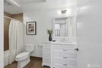 Lovely vanity with Marble Carrara countertops, tile bath & flooring!