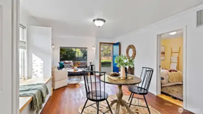 Just the right amount of space - set it up as living and dining areas, or keep it open as one big gathering spot! The cheery blue front door and large picture window bring in great light and offer a lovely view of the fully fenced front yard.