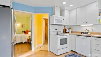 Here’s where the fridge fits perfectly, with a peek into the second bedroom just beyond. Down the hall, you’ll find the bathroom and laundry room - everything laid out with smart, easy flow.