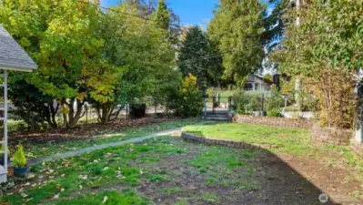 Step through the new wood gate and you'll find yourself in the front yard - and yes, the entire lot is fully fenced! It ties everything together beautifully, creating a sense of continuity, security, and pride of ownership throughout the property.