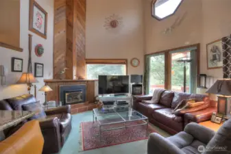 Cathedral ceilings, windows throughout and immaculate cedar woodwork engulfing fireplace makes this home a very unique find.