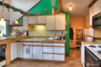 Granite kitchen countertops, glazed porcelain tile flooring and cedar trim.