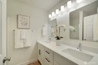 Primary en suite bathroom with double vanities