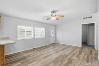 Enter into main living area.  Home has been freshly painted and new flooring throughout.  Move in ready.  Door straight ahead leads to one of two secondary bedrooms.