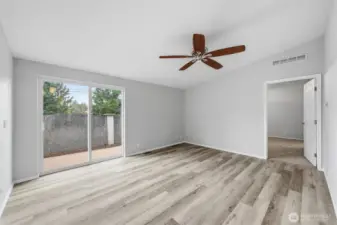 Family room off main living area. Sliding glass door to back deck area.  Door on right leads to primary bedroom.