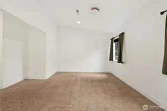 Primary bedroom with vaulted ceilings