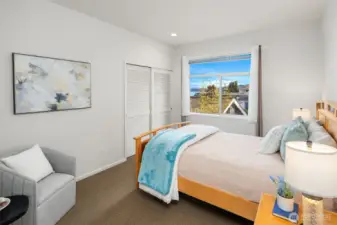 A comfortable secondary bedroom offering partial lake views
