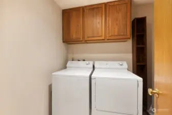 Full sized laundry room with newer water heater. Tons of storage here.