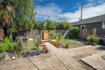 The private backyard has gardening space, a chicken coop (Seller will paint to match home), and access gate to the back alley. The seller had plans drawn for a new garage + additional ADU(s) above, a truly versatile space.