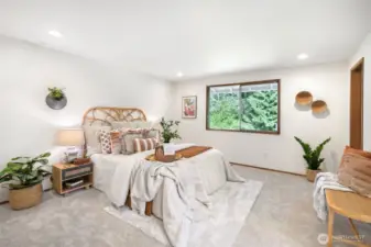 Down the hall, the spacious primary suite is a true sanctuary.