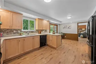 This view shows the kitchen, eating area and fireside family room.