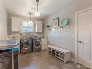 Dedicated Laundry Room – Ample storage and workspace.