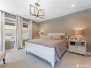 Primary Bedroom Retreat – Peaceful and private with natural light and views.