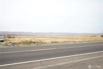 View of the whole property from across the street. Building on theft and fence on right are the neighboring properties.