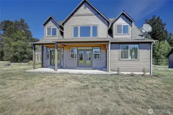 back of home - french doors to patio area overlooking your pastures