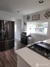 Entrance to upstairs room, the utility space and backyard off the kitchen.