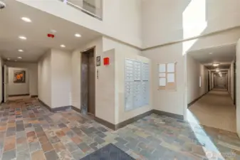 Main entrance to the D building with elevator access and mailboxes.