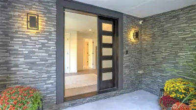 Welcoming and modern stone entry with clean architectural lines.