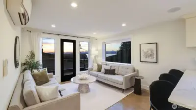 Light filled living room with loads of natural light and a deck to take advantage of the views. Deck is plumbed for gas BBQ, too!