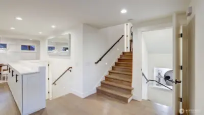 Short flight of stairs leads to the main sleeping areas, utility room, and another full bathroom.