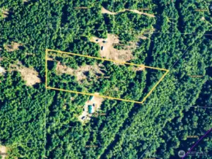 Aerial photo of the site showing the property lines. Road access at w & E of the property.