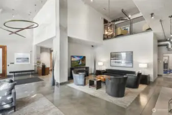 Step into the welcoming and chic Mosler Lofts lobby, showcasing polished concrete floors, a mix of industrial and contemporary design elements, and inviting seating areas.