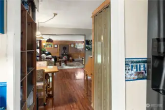 Looking from the kitchen toward the living room. Pantry closet on the left. Breakfast nook beyond that.