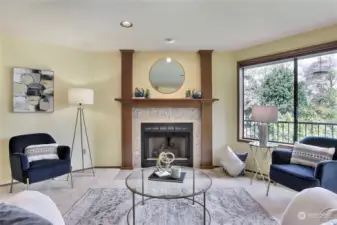 generous living room with cozy gas fireplace and built-in cabinets.