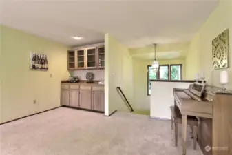 generous living room with cozy gas fireplace and built-in cabinets.