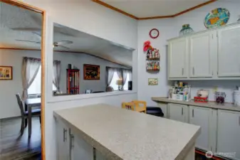 Attached kitchen island with open pass thru to dining.