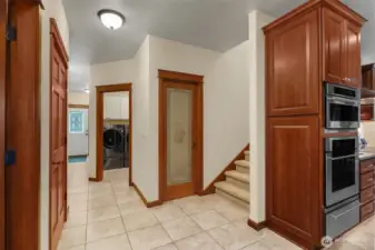 The 2nd door to the laundry, the pantry, and the bonus rm stairs are accessed off the back hall next to the garage interior door.