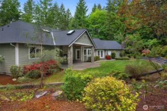 Beautiful mature landscaping. A view of the covered back patio.