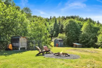 The area just beyond the fire pit was once a garden area. There are apple and cherry trees. This property is ready for your homesteading dreams.