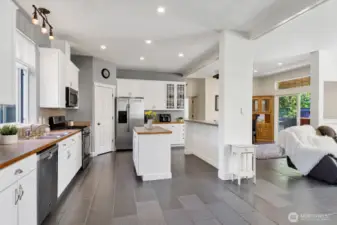 Looking left from the front door to the beautifully remodeled kitchen with stainless steel appliances.