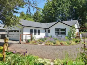 Front of this remodeled home w/ gorgeous landscaping providing your own oasis at the Beach.
