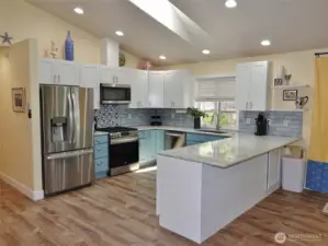 Kitchen w/ slab granite counters.