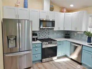 Kitchen w/ newer Stainless Steel appliances.
