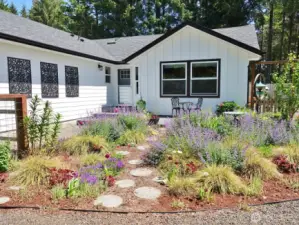 Beautiful flowers, shrubs and trees with paver stones.