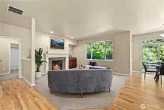 Cozy second living room with gas fireplace and greenbelt views – Puyallup, WA    This inviting second living room in Puyallup’s LaGrande Station community offers a perfect blend of comfort and tranquility. A large picture window frames lush greenbelt views, filling the space with natural light and a peaceful ambiance. The cozy gas fireplace with tile surround and elegant white mantle adds warmth and charm, while the built-in cabinet nook offers display or storage space. Whether you're relaxing after a long day or entertaining guests, this living room delivers serene comfort in one of Puyallup, WA’s most desirable neighborhoods.