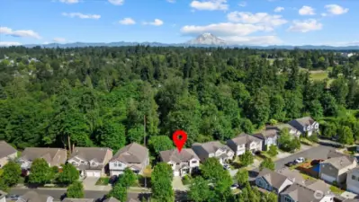 This stunning aerial captures the home's unbeatable location—nestled in a peaceful cul-de-sac, backing to a serene greenbelt, and framed by breathtaking views of Mount Rainier. Enjoy privacy, nature, and beauty—all in the heart of Puyallup’s desirable South Hill neighborhood. Homes with this setting are rare!