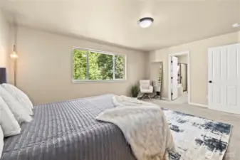 Upstairs primary suite with ensuite bathroom and peaceful greenbelt view – Puyallup, WA    Wake up to nature in this upstairs primary bedroom retreat, featuring lush greenbelt views and direct access to a private spa-style ensuite bathroom. Located in the highly sought-after LaGrande Station neighborhood in Puyallup, this serene space offers a cozy reading nook, soft carpeting, and abundant natural light. A perfect sanctuary after a long day, all while being minutes from the Sounder Train, South Hill Mall, and top-rated schools.