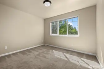 This upstairs bedroom in Puyallup’s LaGrande Station community offers a peaceful retreat with a front-facing window that overlooks Chateau Dr. Located on the top floor, the room is filled with natural light and features neutral carpet, soft paint tones, and a functional layout ideal for a guest room, home office, or personal sanctuary. Enjoy views of the tree-lined street and neighborhood charm from this bright and versatile space in one of Puyallup, WA’s most sought-after locations.