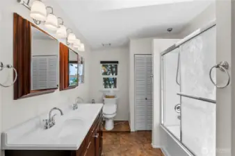 Double sinks, mirrors and lights for those who don't share super well. Toilet with a bidet, linen storage closet and full tub with shower. You're set.