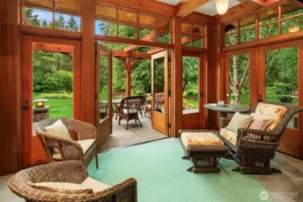 Cozy sunroom opens to the dining room through sliding glass doors as well as opening to the exterior stone terrace.