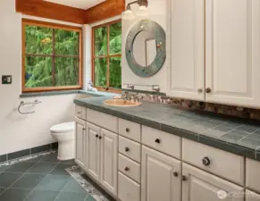 Upper level bathroom with shower and special stone design details