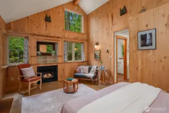 Guest house interior showing vaulted ceilings and fireplace with custom wood touches throughout.