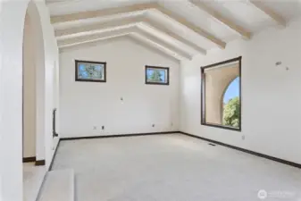 Living room with fireplace behind in this view