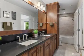 This bathroom stands alone as a full guest bath + it has a private entrance from the 2nd bedroom to function as an en-suite bathroom. Every shower in this home is tiled to the ceiling!