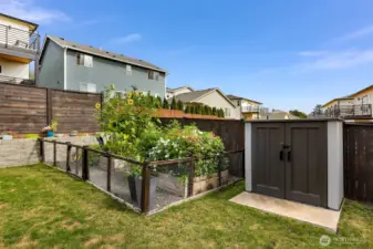 Fenced garden area and easy access tool shed.