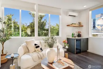 Walls of windows bring in a lot of natural light, and a beverage fridge for entertaining.
